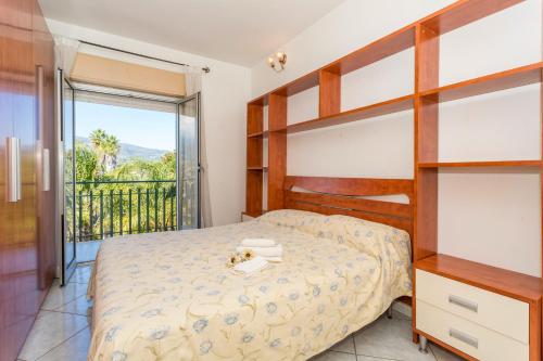 a bedroom with a bunk bed and a balcony at I Ciottoli Dello Ionio in Mascali