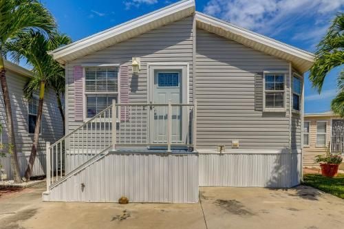 a house with a white fence in front of it at Cozy Jensen Beach Home Pool Access, Walk to Beach in Jensen Beach