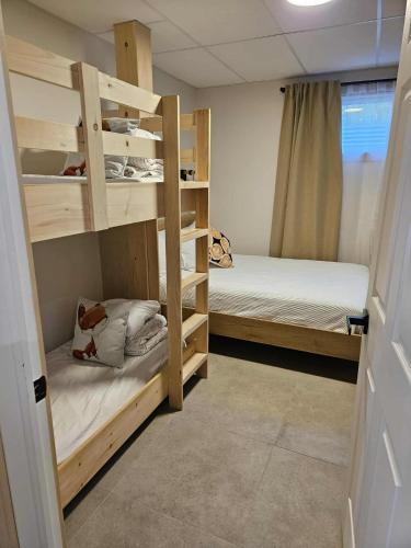 a room with two bunk beds and a window at La Renardière des Monts in Les Éboulements