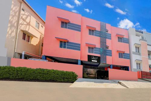 a pink building with a sign in front of it at Collection O DLF IT Park Ramapuram in Chennai