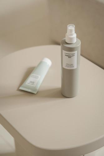 a bottle of medication sitting next to a remote control at Mode Eco Mood Hotel - Adults Friendly in Rimini