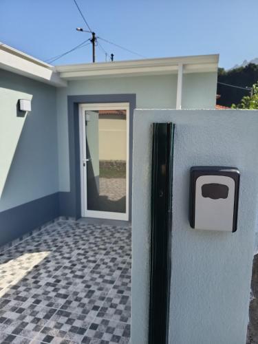 a door to a house with a tile floor at Pousada Teixeira 11C in São Vicente