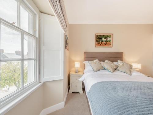 a bedroom with a bed and a window at The Anchorage in Pembroke