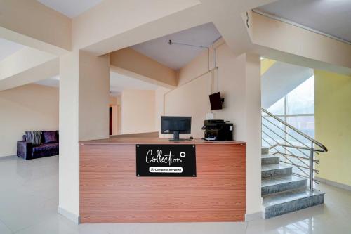 a lobby with a counter with a sign on it at Collection O Abbigere MLV Grand in Jālahalli