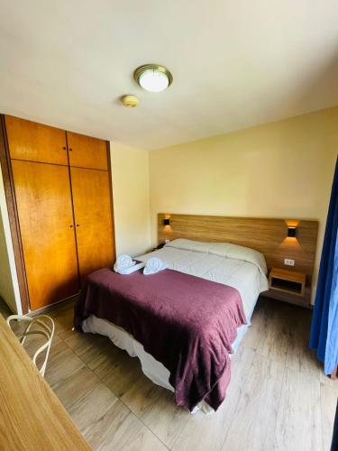 a bedroom with two beds in a room at Hotel Garnier in Campos do Jordão