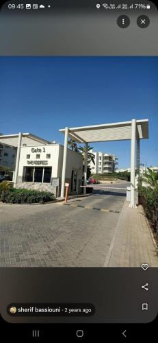 a view of a gas station with a building at Luxerious apartment with a private garden and pool access in Sheikh Zayed