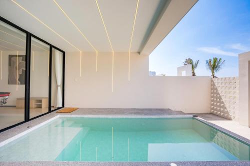 a swimming pool in the middle of a house at hiii Aura Villa Hotel Pattaya Central in Pattaya Central