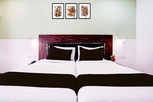 a bedroom with a large bed with two pillows at Collection O Navi Mumbai Formerly IVY Hotel in Mumbai