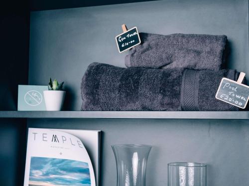 a shelf with towels and a sign that reads tempur at Aparthotel Adagio Malta Central in Msida