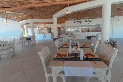 a dining room with a table with food on it at Couzy stylish stays 3 Bdrm Watamu with Beach access in Watamu