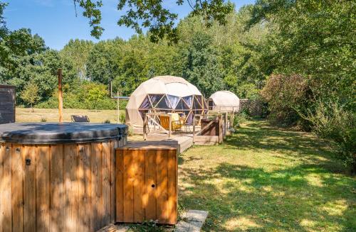 a gazebo in a yard with a wooden fence at Petit dôme in Biziat