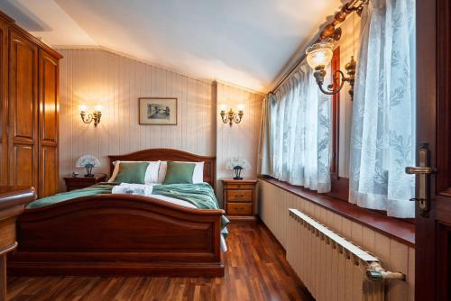 a bedroom with a wooden bed and a window at San Mauro Prestige House - Burano Island in Venice