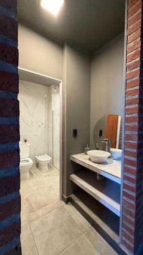 a bathroom with two sinks and a toilet in it at TempoJUY in San Salvador de Jujuy
