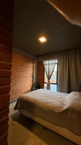 a bedroom with a large bed and a window at TempoJUY in San Salvador de Jujuy
