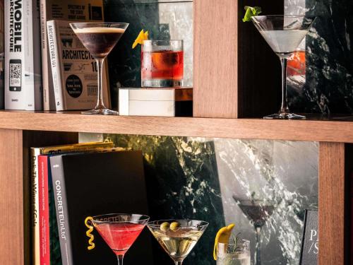 a shelf with two martini glasses and a book at Mondrian Seoul Itaewon in Seoul