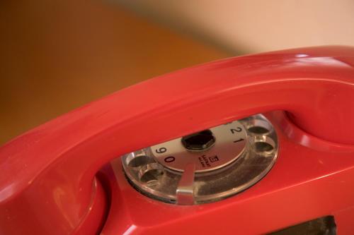 a close up of a red phone at San Gabriele in Loreto