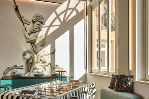 a statue of a tennis player next to a window at JO&JOE ROMA in Rome