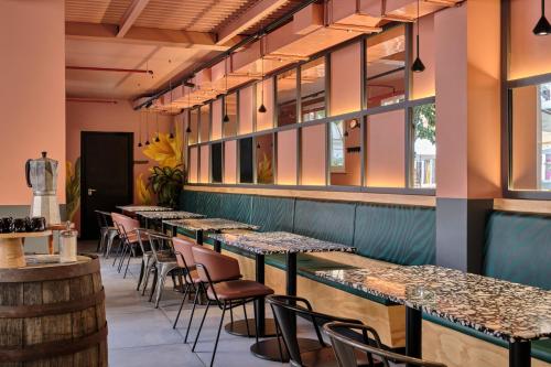 a row of tables and chairs in a restaurant at JO&JOE ROMA in Rome