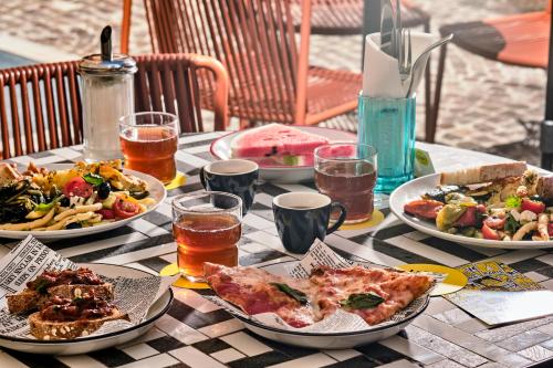 a table with plates of food and drinks on it at JO&JOE ROMA in Rome