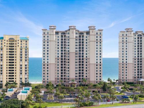 a large building with the ocean in the background at Indigo East 1003 in Perdido Key