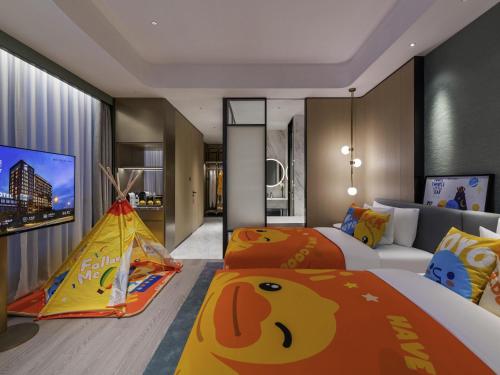a bedroom with two beds and a play tent at Novotel Shanghai Caohejing in Shanghai