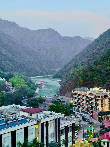 a view of a city with a river and mountains at The Nature's Nook - Best Stay in Shivpuri, Rishikesh, Hotel & Rooms in Shivpuri