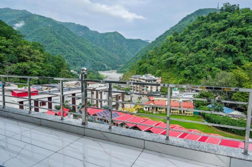a view from the balcony of a resort with mountains at The Nature's Nook - Best Stay in Shivpuri, Rishikesh, Hotel & Rooms in Shivpuri