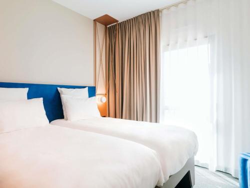 Ένα ή περισσότερα κρεβάτια σε δωμάτιο στο Mercure Brest Centre Port