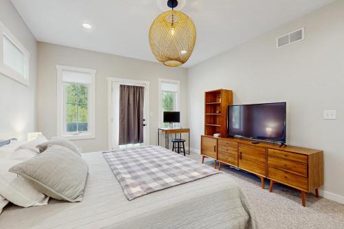 a bedroom with a large bed and a flat screen tv at Sawyer Serenity in Sawyer