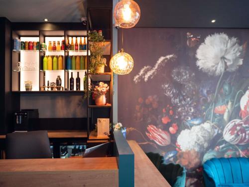 a restaurant with a flower mural on the wall at Ibis Styles Paris Batignolles in Paris