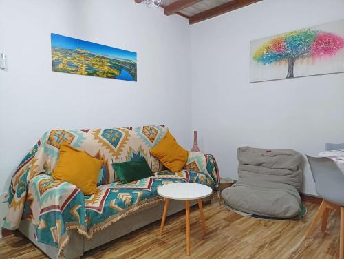a living room with a couch and a table at La Casita de Ale Casa Rural cerca Puy du Fou in Polán