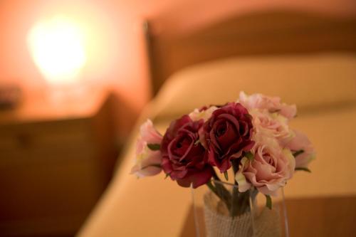 a vase filled with flowers sitting on a table at San Gabriele in Loreto