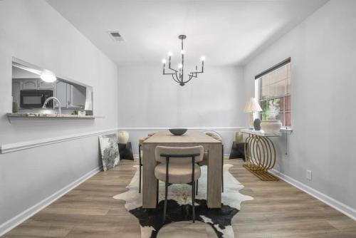 CollegetownにあるBaton Rouge condo near LSUのテーブルとシャンデリアのあるダイニングルーム