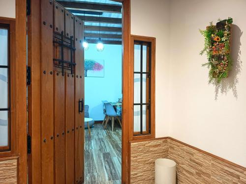 a room with a door and a table with an umbrella at La Casita de Ale Casa Rural cerca Puy du Fou in Polán