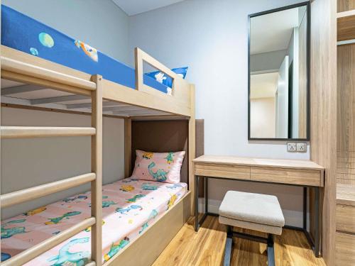 a childs bunk bed with a mirror and a desk at Mercure Living Putrajaya in Putrajaya