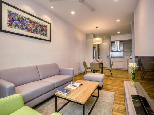 a living room with a couch and a table at Mercure Living Putrajaya in Putrajaya