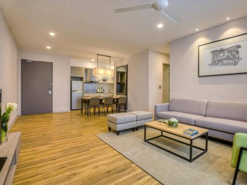a living room with a couch and a table at Mercure Living Putrajaya in Putrajaya