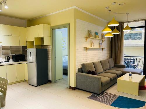 a living room with a couch and a kitchen at Tu Hoa Hotel by Luxe Hospitality in Hanoi