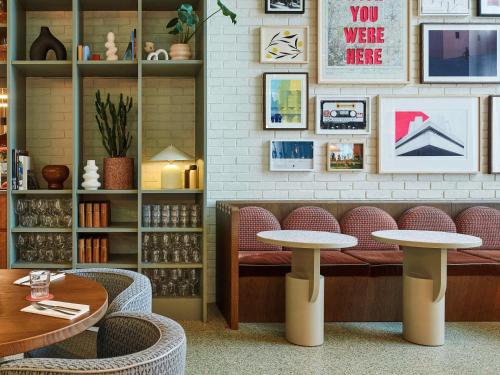 a restaurant with two tables and chairs in a room at TRIBE London Canary Wharf in London