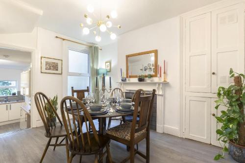 a dining room with a table and chairs at Central 3 Bedroom Home for 7 Guests in Cheltenham