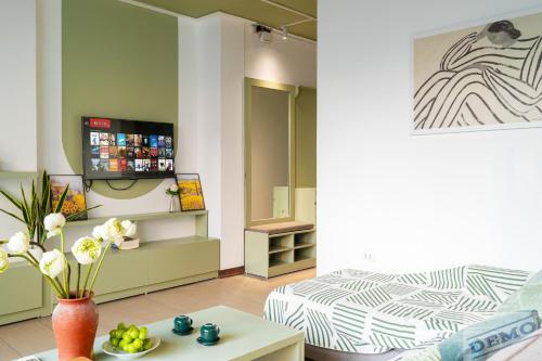 a living room with a bed and a table at Tu Hoa Hotel by Luxe Hospitality in Hanoi