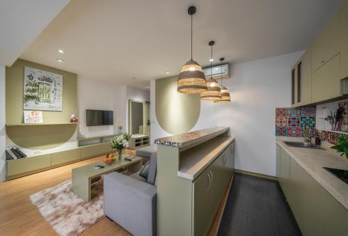 a kitchen with a counter and a living room at Tu Hoa Hotel by Luxe Hospitality in Hanoi