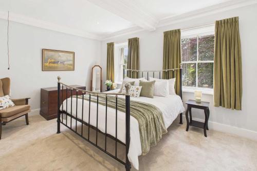 a bedroom with a bed and a chair and a window at Host & Stay - Thorneville House in Knaresborough