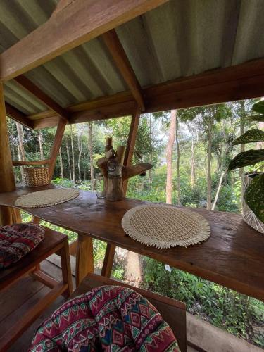 a table in a room with a view of a forest at Forest Retreat House Hammock & Private Terrace in Ban Nok