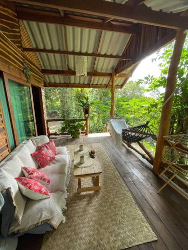 a living room with a couch and a table at Forest Retreat House Hammock & Private Terrace in Ban Nok