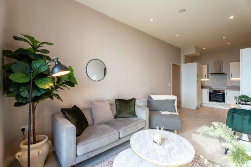 a living room with a couch and a table at Sleek 1BR City Stay - With Sofa Bed in Central Station