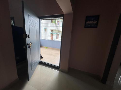 a hallway with a door leading to a patio at Kings Nest - Service Apartment Near VIT, Vellore in Vellore