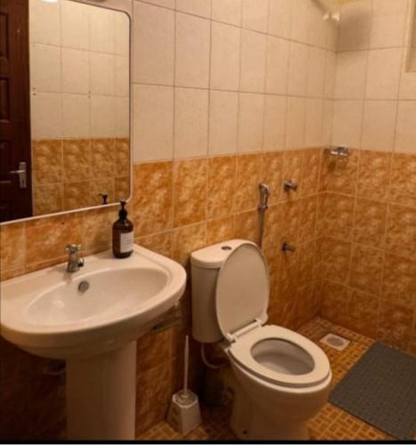 a bathroom with a toilet and a sink at 1BR Luxury Apartment Milimani Nakuru, Empiris with Pool, Gym, Near Golf Club in Nakuru