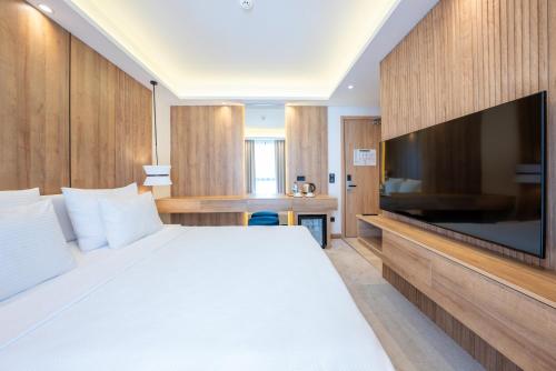 a hotel room with a large bed and a flat screen tv at Premier Lounge Hotel in Tuzla