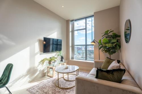 a living room with a couch and a table at Sleek 1BR City Stay - With Sofa Bed in Central Station